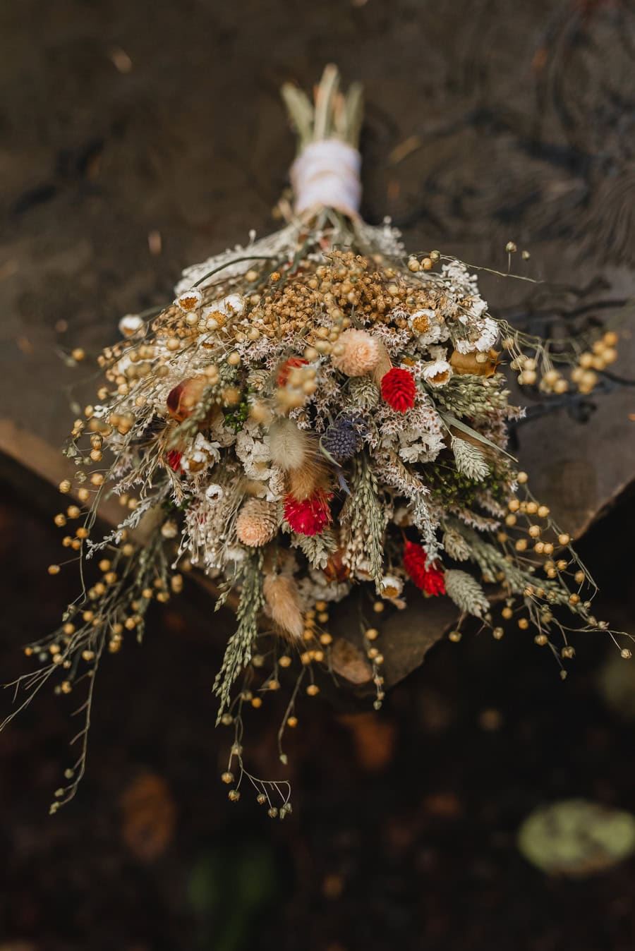 cream, green, and red wedding bouquet with wildflowers and wheatgrasses