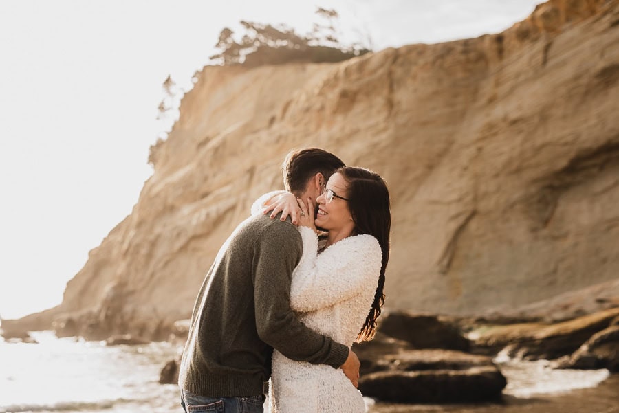 Couple hugging by the ocean at Cape Kiwanda