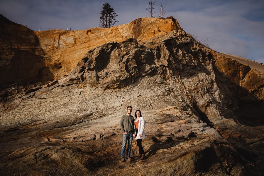 Couple standing in sunlight at Oregon Coast