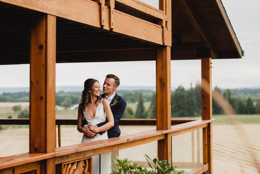 Bride and groom are embracing at Scholls Valley Lodge in wine country.